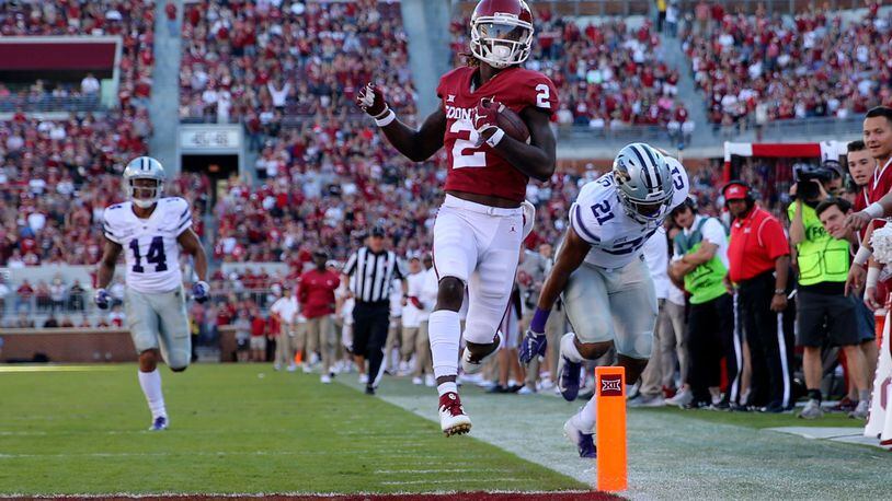 Oklahoma Sooners wide receiver CeeDee Lamb (2) runs for a touchdown past Kansas State Wildcats defensive back Kevion McGee (14) during the second half at Gaylord Family - Oklahoma Memorial Stadium.