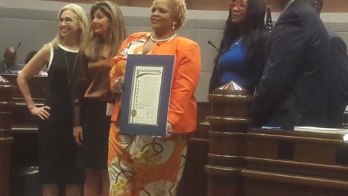 Fulton County Commissioner Khadijah Abdur-Rahman, flanked by other Fulton commissioners, holds a proclamation declaring March 1, 2023, "President Jimmy Carter Appreciation Day."