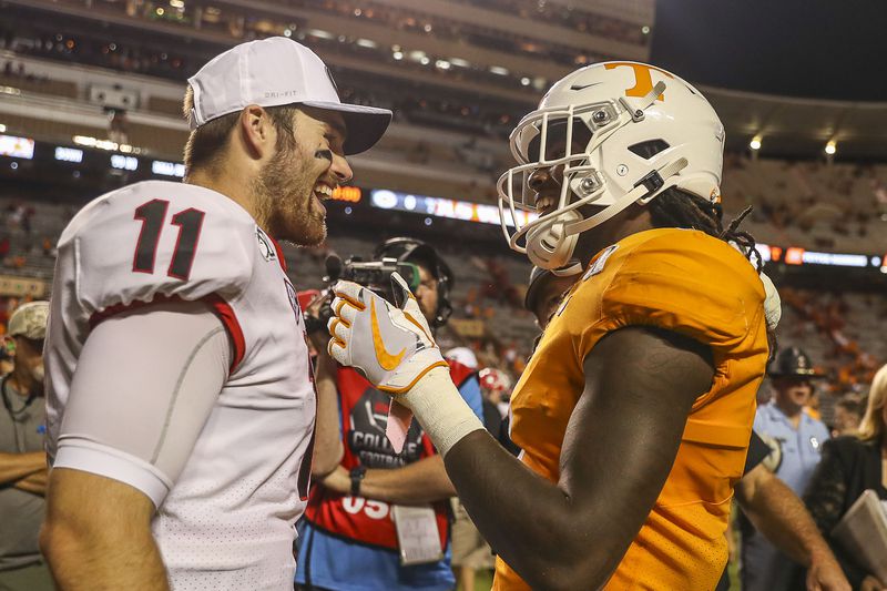 Georgia Bulldogs quarterback Jake Fromm (11) and Tennessee Volunteers wide receiver Marquez Callaway (1) speak following the game.  (Alyssa Pointer/Atlanta Journal Constitution)