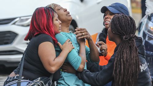 Sanmarian McClain (center-left) is comforted in her grief after losing her daughter to gunfire Thursday, Oct. 3, 2019. An 18-year old woman is dead after a stray bullet flew into her southwest Atlanta home and hit her as she slept. Gunfire erupted Thursday, in the street outside the home in the 2900 block of River Ridge Drive, according to Atlanta homicide commander Lt. Andrea Webster. Officers were sent to the residence about 6 a.m. after a woman reported her daughter had been shot and killed. When officers went inside the home, they found the victim with a gunshot wound to the chest, police said. Emergency medical officials confirmed she was dead.  Investigators learned there was an exchange between at least two shooters that may have lasted several minutes, Webster said. During that time, three stray bullets came into the house, one of which hit and killed the sleeping teen, she said.  âWe canât think of any reason she may have been the subject or the target,â Webster said.  The 18-year-old, identified by relatives as Jessica Daniels, had just graduated from South Atlanta High School in May, her mother told police.