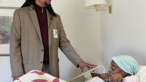 In this file photo, Kevin Dunn sings gospel songs 100 year-old Beulah Burton at West Georgia Hospice in LaGrange on a recent Monday. PHIL SKINNER / PSKINNER@AJC.COM