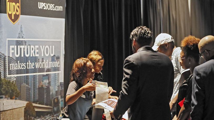 Erika Solomon, from UPS, talks with potential job applicants at a job fair earlier this month. The Opportunity ATL job and resource fair took place in East Point. Bob Andres / robert.andres@ajc.com