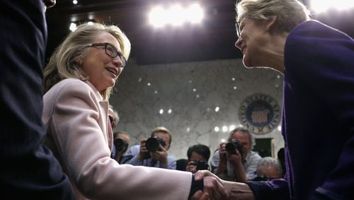 U.S. Secretary of State Hillary Clinton (L) greets Sen. Elizabeth Warren (D-MA) as they arrive for Sen. John Kerry's (D-MA) confirmation hearing before the Senate Foreign Relations Committee to become the next Secretary of State in the Hart Senate Office Building on Capitol Hill January 24, 2013 in Washington, DC. Nominated by President Barack Obama to succeed Hillary Clinton as Secretary of State, Kerry has served on this committee for 28 years and has been chairman for four of those years. (Photo by Chip Somodevilla/Getty Images)