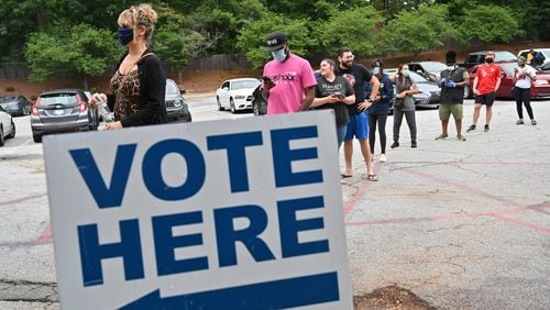 DeKalb County residents wait outside Ray Hope Christian Church in Decatur to cast their votes in the Georgia primary after 7 p.m. Tuesday, the original poll closing time. (Hyosub Shin / Hyosub.Shin@ajc.com)