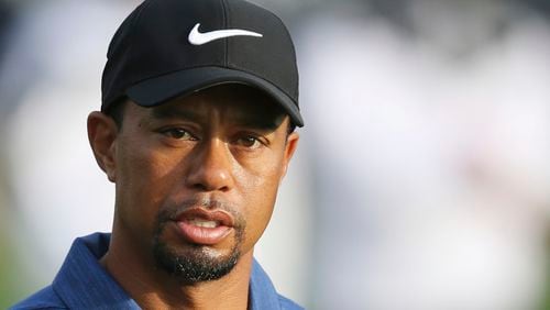 In this Feb. 2, 2017, file photo, Tiger Woods reacts on the 10th hole during the first round of the Dubai Desert Classic golf tournament in Dubai, United Arab Emirates. (AP Photo/Kamran Jebreili, File)