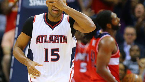 050515 ATLANTA: Hawks center Al Horford covers his face in disbelief after making a shot against the Wizards in a basketball game during the Eastern Conference Semifinals game 2 on Tuesday, May 5, 2015, in Atlanta. The Hawks beat the Wizards 106-90 to even the series 1-1. Curtis Compton / ccompton@ajc.com It's OK to look now: The Hawks survived a scare and beat Washington to even their playoff series. (Curtis Compton, ccompton@ajc.com)