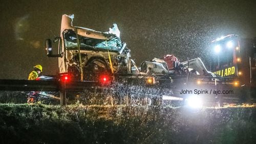 Crews loaded wrecked vehicles on trailers on the scene of a fatal wreck on I-85 South. Two tractor-trailers were involved in the crash that killed two people, according to police.