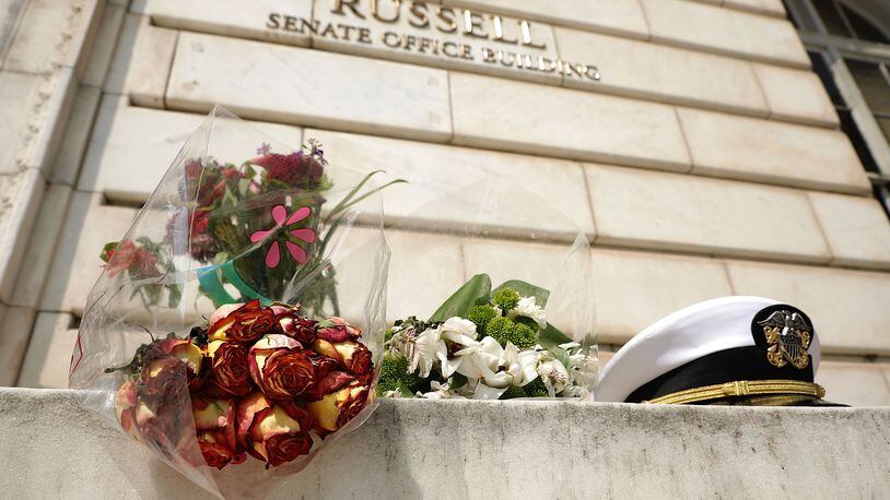 An impromptu memorial of flowers and a U.S. Navy officer’s hat outside of the Russell Senate Office Building in honor of U.S. Sen. John McCain, R-Ariz. Chip Somodevilla/Getty Images