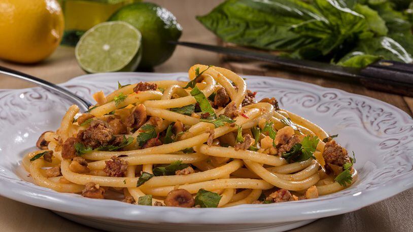 Bucatini, a long, spaghetti-like noodle with a hole running through the length of it, is tossed with hazelnuts, red pepper paste, lamb and fresh herbs. (Zbigniew Bzdak/Chicago Tribune/TNS)