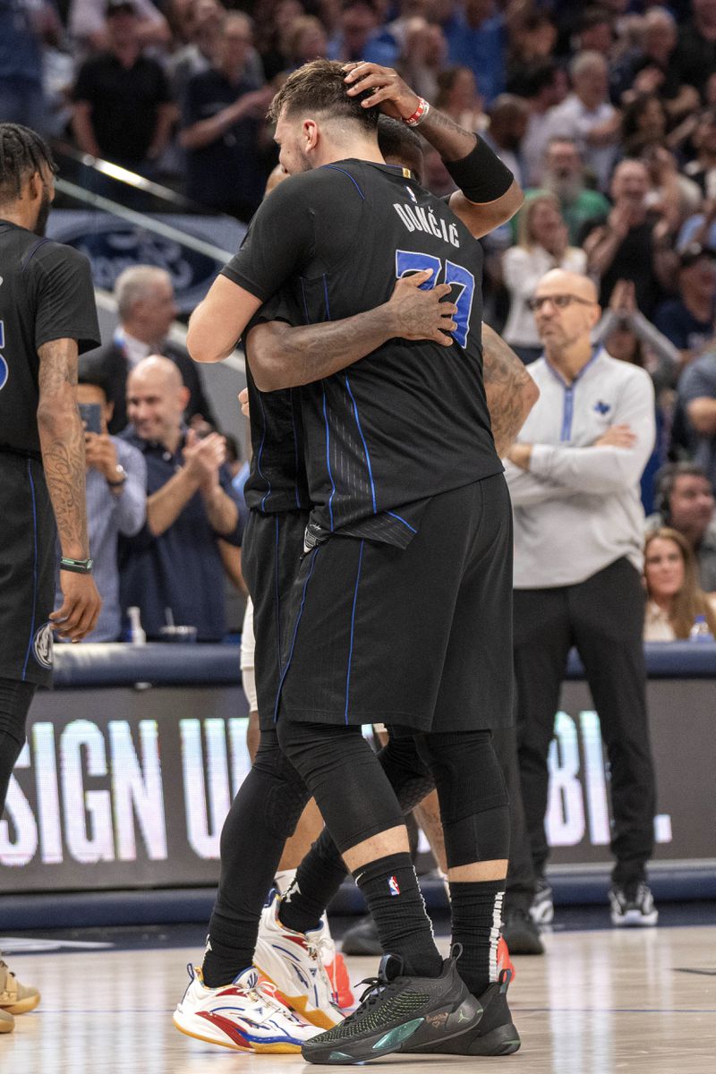 Dallas Mavericks guard Luka Doncic (77) embraces guard Kyrie Irving after Irving hit a 3-point basket late in the fourth quarter of an NBA basketball first-round playoff series against the Los Angeles Clippers Friday, May 3, 2024, in Dallas. (AP Photo/Jeffrey McWhorter)