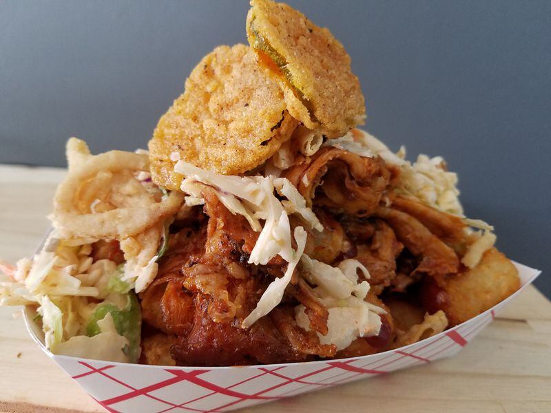 The Devil Went Down to Georgia tots from Super Tot Truck are loaded with smoked pork, a Cherry Coke-chipotle barbecue sauce, sriracha-ranch slaw, crispy fried onion strings and fried pickles. Photo: courtesy of Super Tot Truck