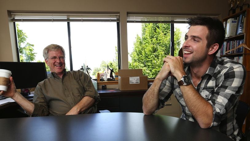 Travel writer and showman Rick Steves, left, with his son Andy Steves, right, who is following in his father’s footsteps, on June 13, 2016, in Rick’s Edmonds, Wash., offices. (Ken Lambert/Seattle Times/TNS)