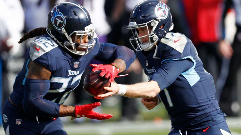Tennessee Titans running back Derrick Henry (22) takes a handoff from quarterback Ryan Tannehill (17) in the first half of an NFL wild-card playoff game against the Baltimore Ravens Sunday, Jan. 10, 2021, in Nashville, Tenn. (Wade Payne/AP)