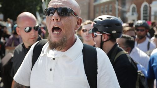 CHARLOTTESVILLE, VA - AUGUST 12: White nationalists, neo-Nazis and members of the "alt-right" exchange insults with counter-protesters as they enter Emancipation Park during the "Unite the Right" rally August 12, 2017 in Charlottesville, Virginia. After clashes with anti-fascist protesters and police the rally was declared an unlawful gathering and people were forced out of Emancipation Park, where a statue of Confederate General Robert E. Lee is slated to be removed. (Photo by Chip Somodevilla/Getty Images)