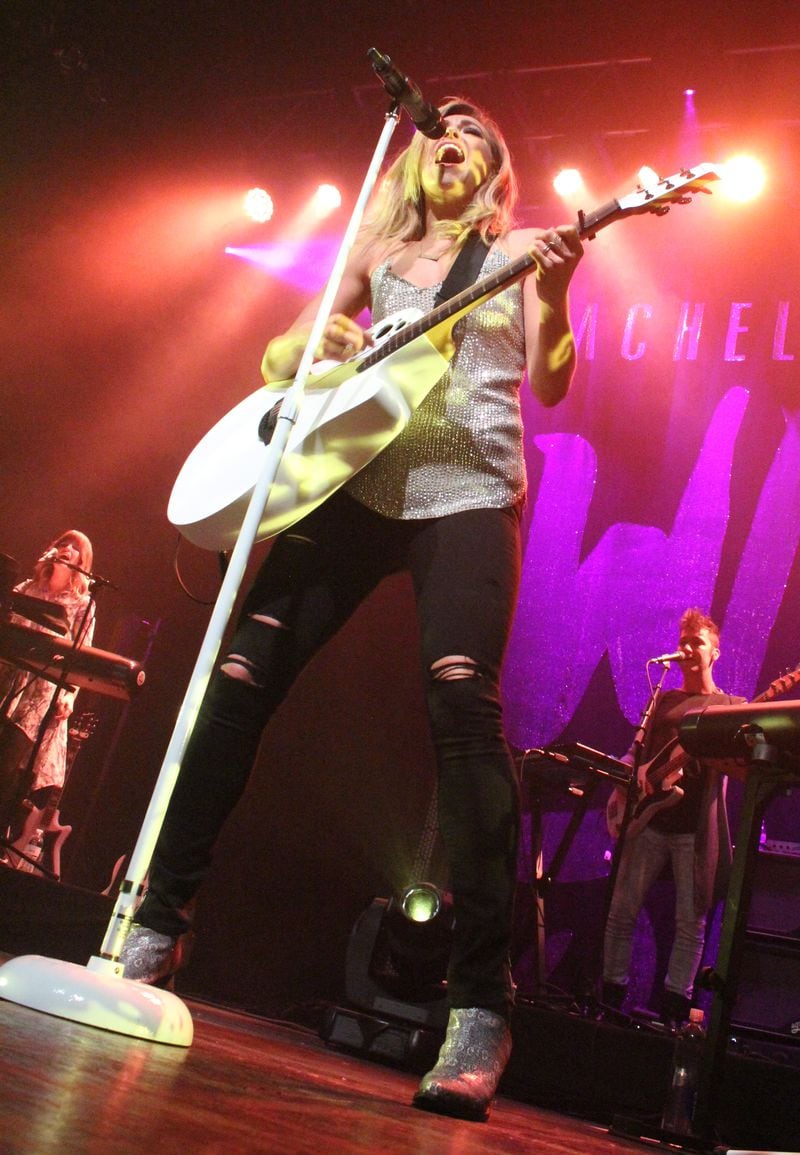 She can rock a guitar AND a mic. Photo: Melissa Ruggieri/AJC