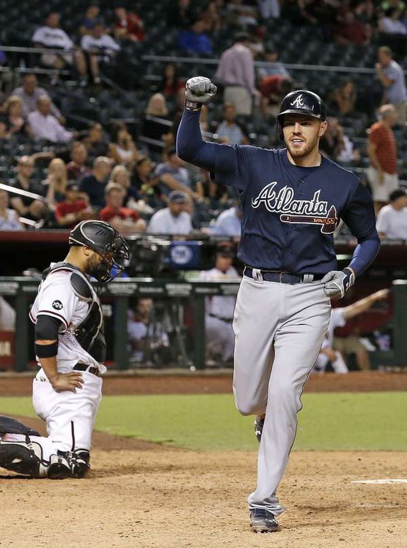 Freddie Freeman crosses the plate after his game-tying homer in the ninth inning Monday. (AP photo)