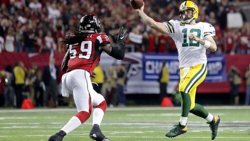 Aaron Rodgers of the Packers looks to pass in the second half against De'Vondre Campbell of the Falcons in the NFC Championship Game at the Georgia Dome on January 22 in Atlanta.