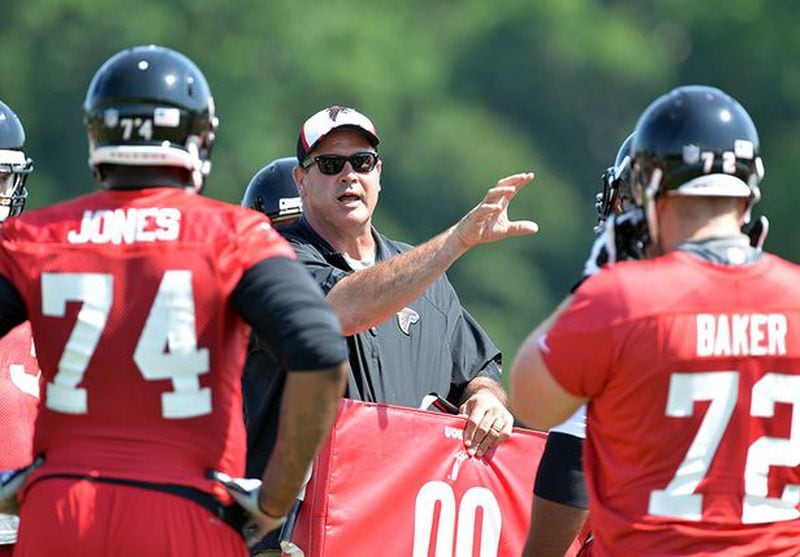 Falcons offensive line coach Mike Tice talks with players during Atlanta Falcons OTAs in Flowery Branch, Wednesday, May 28, 2014. (By Kent D. Johnson/kjohnson@ajc.com)