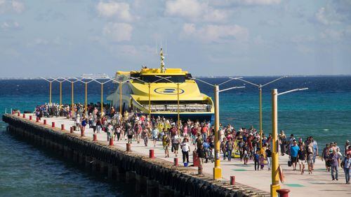 Tourists and passengers disembark from a ferry on to the wharf on Playa del Carmen, Mexico, Friday, March 2, 2018. Undetonated explosives were found on another ferry that runs between the Caribbean resorts of Playa del Carmen and the island of Cozumel, authorities said, less than two weeks after a blast shook another ferry plying the same route. (AP Photo/Gabriel Alcocer)