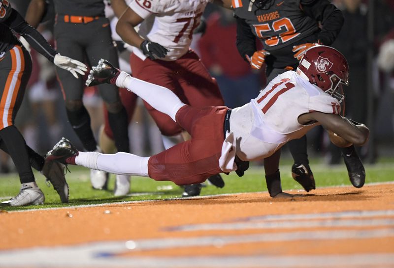 Lowndes quarterback Jacurri Brown (11) dives into the end zone for a touchdown against North Cobb late in the second half Friday, Dec. 4, 2020, in Kennesaw. (Daniel Varnado/For the AJC)