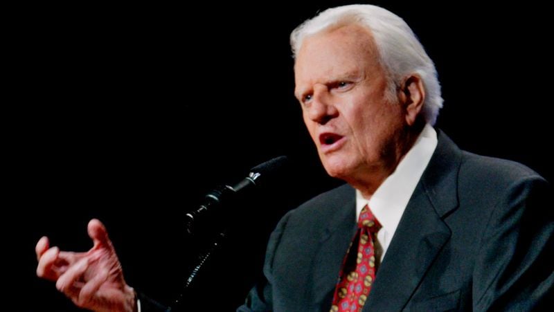 FILE - In this June 12, 2003 file photo, the Rev. Billy Graham preaches in Oklahoma City, Okla. Graham, who died Wednesday, Feb. 21, 2018, at his home in North Carolina's mountains at age 99, reached hundreds of millions of listeners around the world with his rallies and his pioneering use of television. Graham's body will be brought to his hometown of Charlotte on Saturday, Feb. 24, as part of a procession expected to draw crowds of well-wishers. (AP Photo/Sue Ogrocki, File)