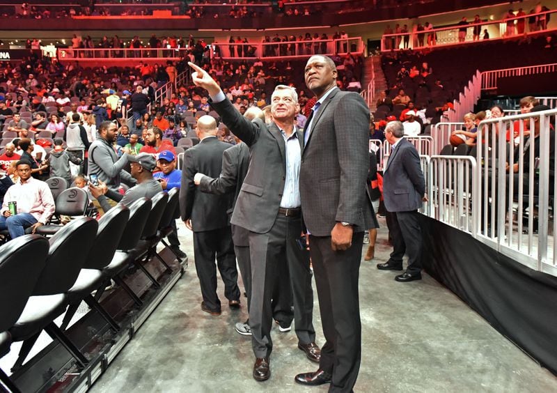  Hawks principal owner Tony Ressler  and former Hawks superstar   Dominique Wilkins talk during State Farm Arena’s open house on Saturday.  