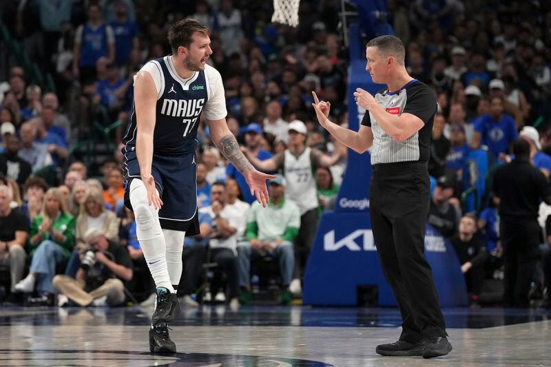 Dallas Mavericks guard Luka Doncic, left, argues a call with a referee, right, during the second half of Game 4 of an NBA basketball first-round playoff series against the Los Angeles Clippers Sunday, April 28, 2024, in Dallas. (AP Photo/Jeffrey McWhorter)