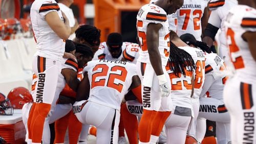 Members of the Cleveland Browns kneel before Monday night's NFL exhibition game.