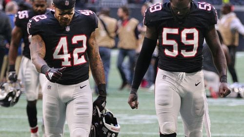 Atlanta Falcons linebackers Duke Riley (left) and De’Vondre Campbell walk off the field after falling to the Dallas Cowboys 22-19  on Sunday, Nov. 18, 2018, in Atlanta.