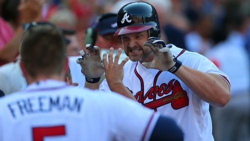 David Ross, right, played four seasons for the Braves, from 2009 to 2012. CURTIS COMPTON / CCOMPTON@AJC.COM