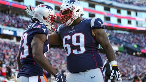 New England's Shaq Mason (69) offers his hearty congratulations to Phillip Dorsett following yet another Patriot touchdown.