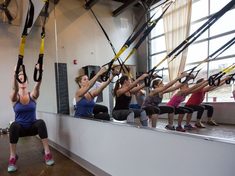 In this file photo, a group of women work out during a TRX class at Pace23 Indoor Cycling & TRX in Decatur.  CONTRIBUTED BY BRANDEN CAMP 2015