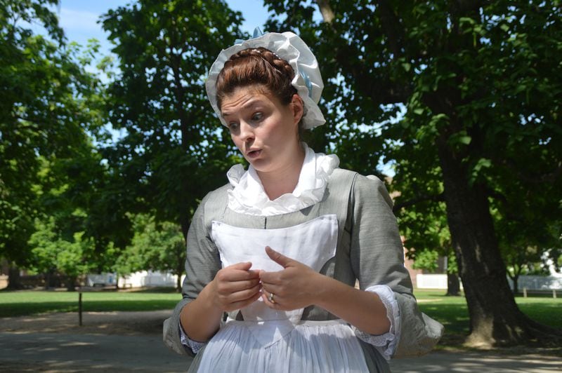 Costumed interpreters known as nation builders remain in character to provide an authentic interactive experience for guests, as evidenced by this woman who spends her days reenacting the life of an actual school teacher from Williamsburg's earliest days. (Myscha Theriault/TNS)