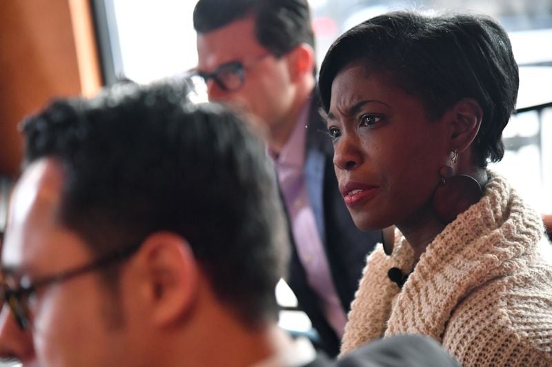 Janelle Jones leads a meeting with members of Millennial Round Table of GA at Urban Grind coffeehouse in Atlanta on Tuesday, December 20, 2016. HYOSUB SHIN / HSHIN@AJC.COM