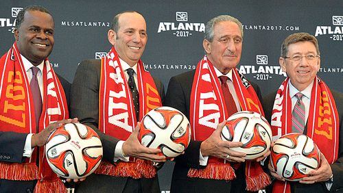 April 16, 2014 Atlanta - Atlanta mayor Kasim Reed (from left), MLS commissioner Don Garber, Falcons owner Arthur Blank and executive director of GWCC Frank Poe pose for a group photograph after the official announcement event in downtown Atlanta on Wednesday, April 16, 2014. MLS commissioner Don Garber, Falcons owner Arthur Blank, mayor Kasim Reed, executive director of GWCC Frank Poe and others officially announced that Atlanta will be the 22nd team in MLS on Wednesday downtown amidst a parade-like atmosphere. HYOSUB SHIN / HSHIN@AJC.COM