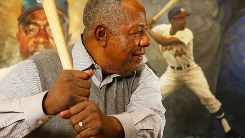 Braves legend Hank Aaron shows he still has his form from his four decades as a slugger.