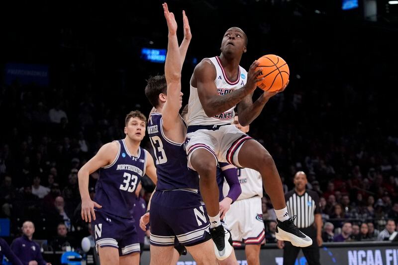 FILE - Florida Atlantic's Johnell Davis (1) drives past Northwestern's Brooks Barnhizer (13) during the first half of a first-round college basketball game in the NCAA Tournament, Friday, March 22, 2024, in New York. Davis has committed to play for John Calipari at Arkansas. (AP Photo/Frank Franklin II, File)