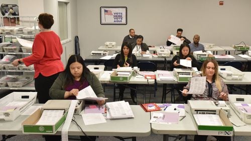 Gwinnett County poll workers count provisional ballots at Gwinnett County Voter Registrations and Elections Office in Lawrenceville on Tuesday, November 13, 2018. HYOSUB SHIN / HSHIN@AJC.COM
