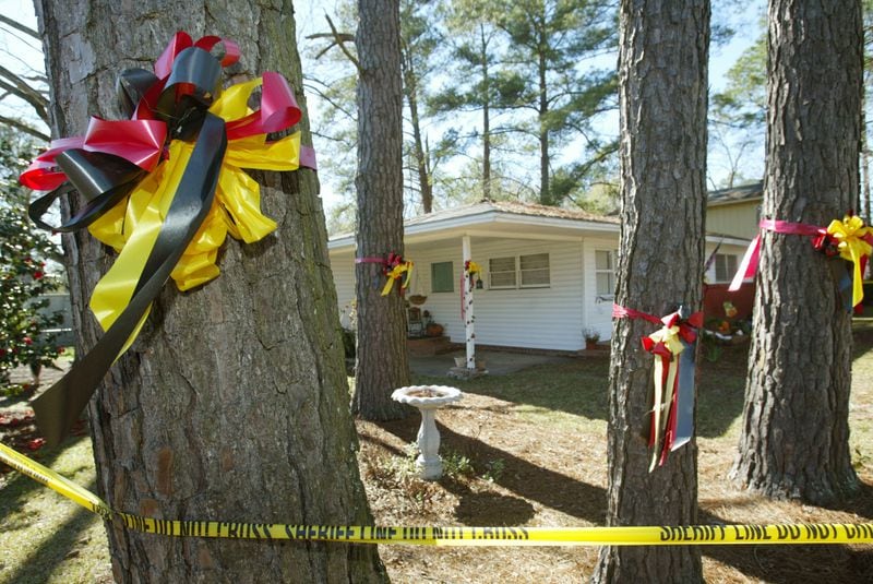 Law enforcement tape matches the color of ribbons tied to the pines at the home of Tara Grinstead (above), a high school teacher who has been missing since Oct. 22. The scene is one of many public reminders that folks miss her in the Irwin County town of Ocilla.   (JENNI GIRTMAN / AJC staff)