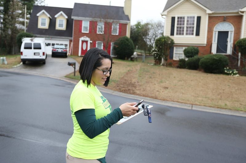 2/22/19 - Norcross - Michelle Sanchez with the New Georgia Project Action Fund looks for the next address while canvassing in support of the MARTA referendum on Friday, February 22, 2019 in Norcross, Georgia. Early voting for the referendum begins on February 25. The election is March 19. The New Georgia Project Action Fund have already knocked on thousands of doors and don’t plan to slow down anytime soon. EMILY HANEY / emily.haney@ajc.com
