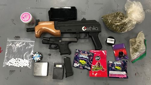 Police said guns and drugs were recovered from the car of a Jonesboro man who was involved in a road-rage incident Monday in Clayton County.