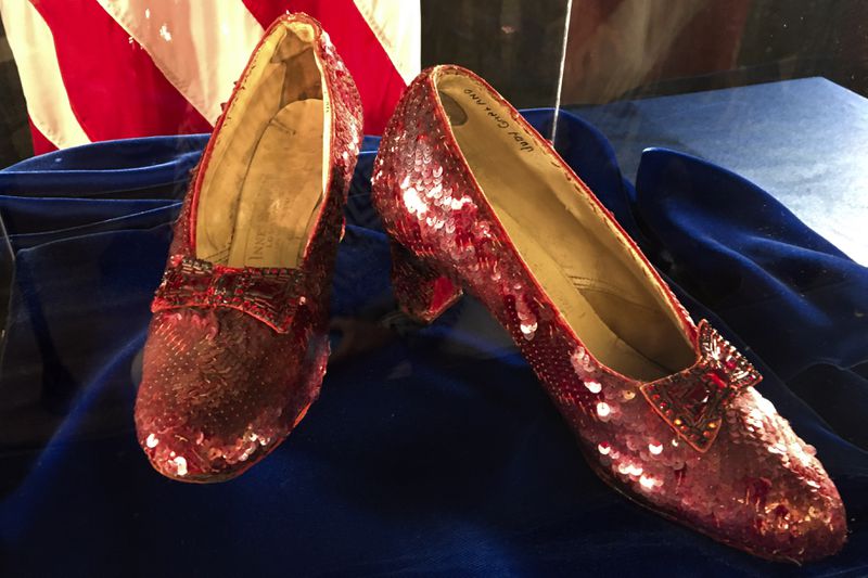 FILE - Ruby slippers once worn by Judy Garland in the "The Wizard of Oz" are displayed at a news conference, Sept. 4, 2018, at the FBI office in Brooklyn Center, Minn. In an odd quirk of the “Wizard of Oz” rights, the film's most famous artifact, Dorothy's ruby slippers, are still the intellectual property of MGM via the 1939 film. In Frank Baum's book, the shoes were silver. (AP Photo/Jeff Baenen, File)