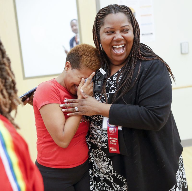Dance instructor Lisa Perrymond, left, cries as Principal Dione Simon Taylor hugs her after watching a dance rehearsal in October for the 2019 State of the District. Bob Andres / robert.andres@ajc.com