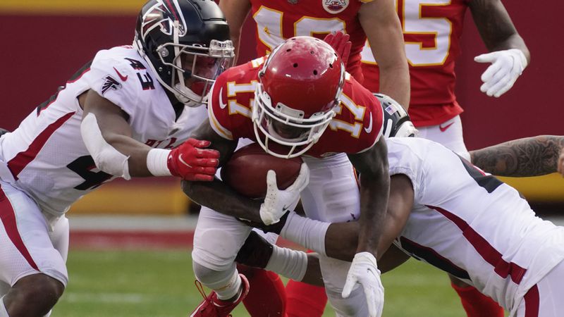 Kansas City Chiefs wide receiver Mecole Hardman is tackled by Atlanta Falcons Mykal Walker, left, and Sharrod Neasman during the second half Sunday, Dec. 27, 2020, in Kansas City, Mo. (Charlie Riedel/AP)