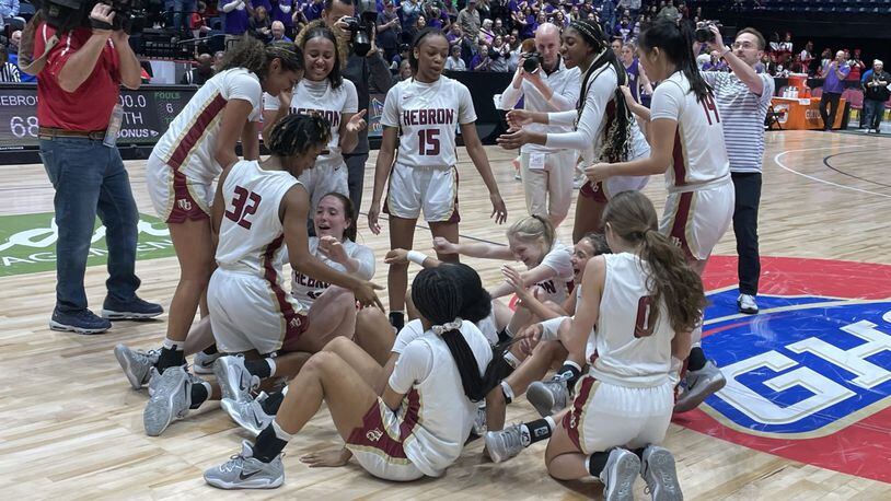 Hebron Christian players celebrate their 68-36 victory over Lumpkin County in the Class 3A girls basketball championship game at the Macon Coliseum on March 10, 2023.