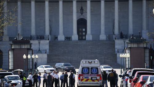 Law enforcement and rescue vehicle are seen on a street leading to Capitol Hill in Washington, Monday, March 28, 2016, after reports of gunfire at the Capitol Visitor Center complex. (AP Photo/Alex Brandon)
