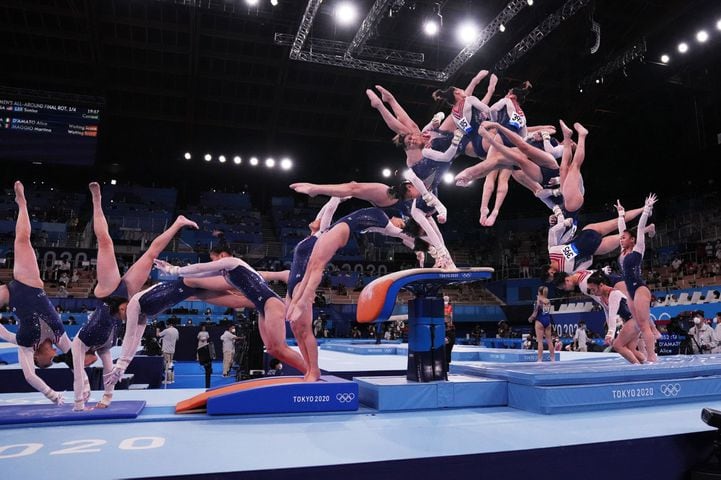 A composite image shows Sunisa Lee of the United States completing a vault during the women's all-around gymnastics competition at the postponed 2020 Tokyo Olympics in Tokyo on Thursday, July 29, 2021. Lee went on to win the gold medal. (Photographs by Emily Rhyne; composite image by Jon Huang/The New York Times)