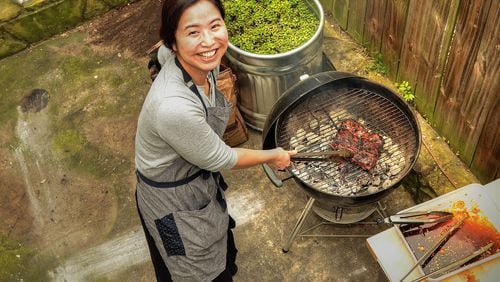Seung Hee Lee cooks on her back porch grill. (Photo by Chris Hunt/Special; styling by Seung Hee Lee.