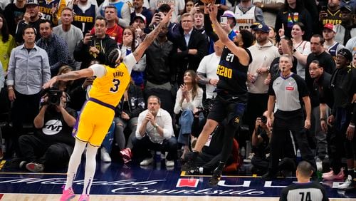 Denver Nuggets guard Jamal Murray (27) hits the game-winning basket against Los Angeles Lakers forward Anthony Davis (3) during the second half in Game 2 of an NBA basketball first-round playoff series Monday, April 22, 2024, in Denver. (AP Photo/Jack Dempsey)
