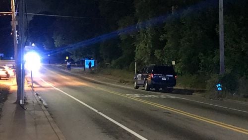 Police are searching for a gray SUV after someone inside the vehicle shot a library security guard in the head Tuesday evening in southwest Atlanta.